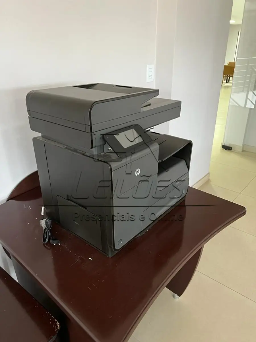 LOTE ÚNICO - Lote com diversos móveis para escritório (mesas para escritório, sendo uma em “L” e outra simples, uma mesa de apoio, um balcão com duas portas, uma estante, um porta CPU, um gaveteiro, duas cadeiras estofadas altas e giratórias, cinco cadeiras estofadas fixas) e uma impressora jato de tinta HP Officejet Pro X476dw MFP, em estado de nova.