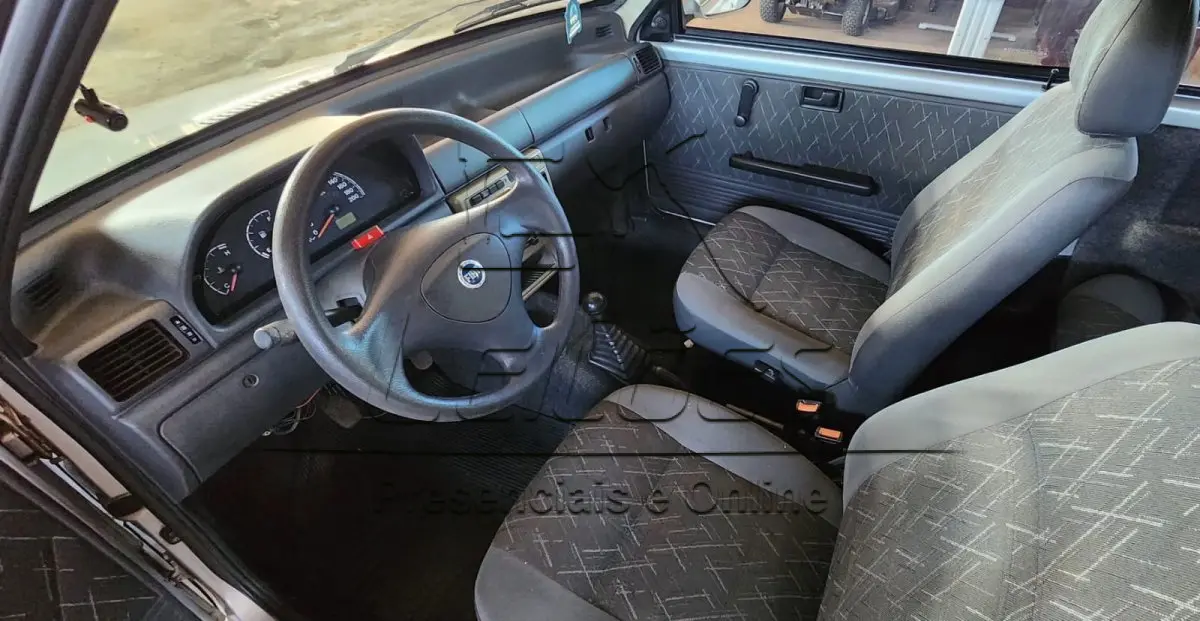 LOTE 006 - Automóvel FIAT/UNO MILLE FIRE FLEX, ano/modelo 2005/2006, cor prata, duas portas, em bom estado de conservação